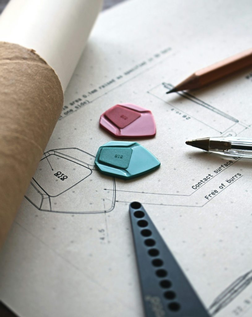 a pair of scissors, a hole punch, and some paper on top of a